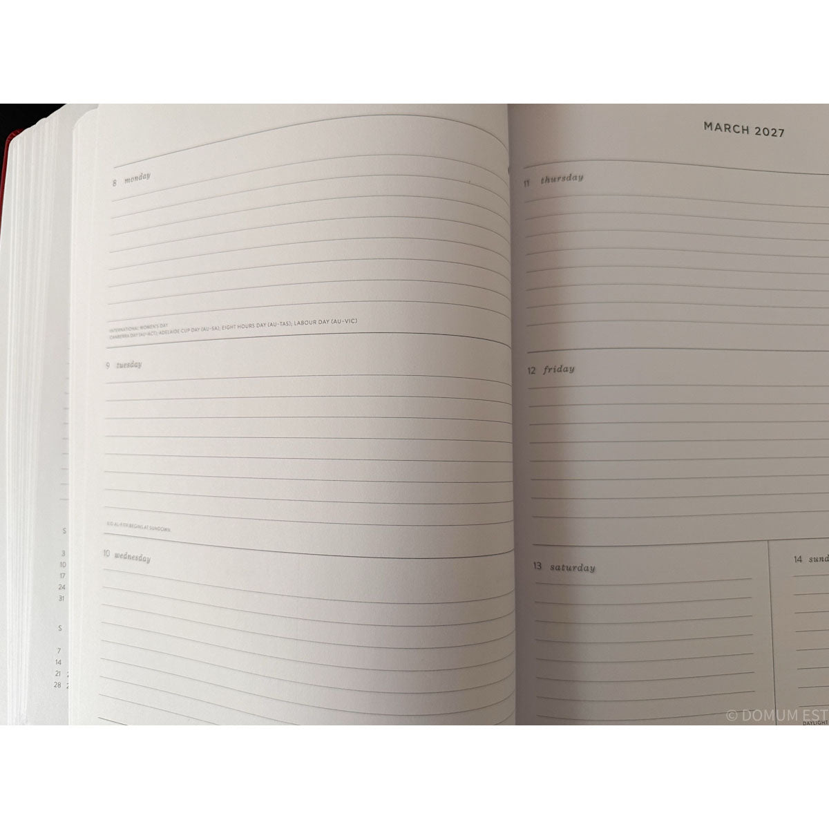 An open planner or notebook showing lined weekly and daily pages for March 2027, photographed against a white background.
