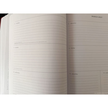 An open planner or notebook showing lined weekly and daily pages for March 2027, photographed against a white background.