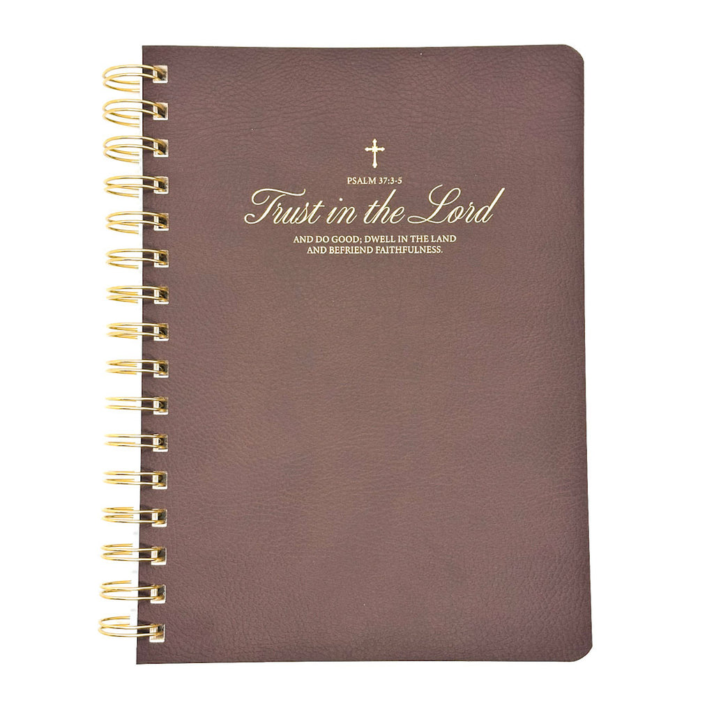 Brown notebook with gold spiral binding and psalm 37 text on a white background