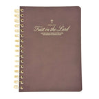 Brown notebook with gold spiral binding and psalm 37 text on a white background