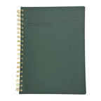 Fringe Studio Green notebook with gold spiral binding on a white background