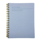 Fringe Studio blue soft leather notebook with gold spiral binding on a white background