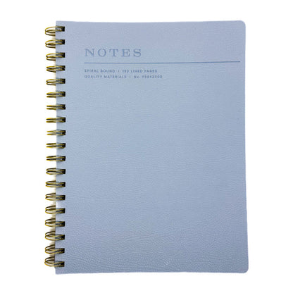 Fringe Studio blue soft leather notebook with gold spiral binding on a white background