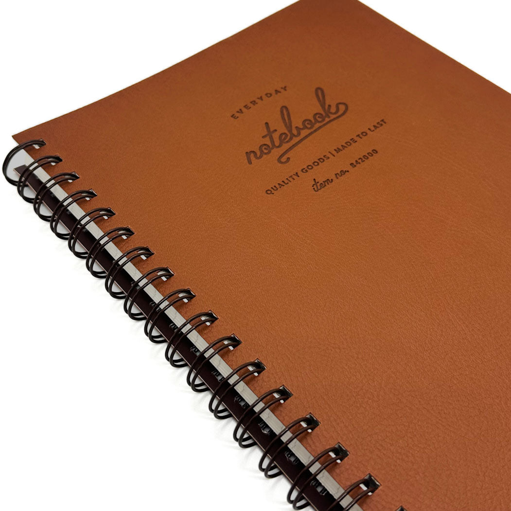 Brown notebook with spiral binding on a white background