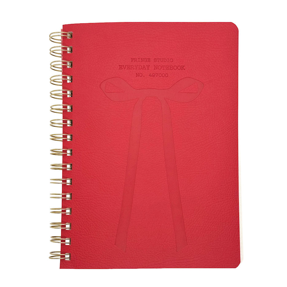 Fringe Studio red notebook with gold spiral binding on a white background