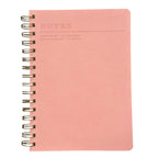 Fringe A5 pink notebook with spiral binding on a white background