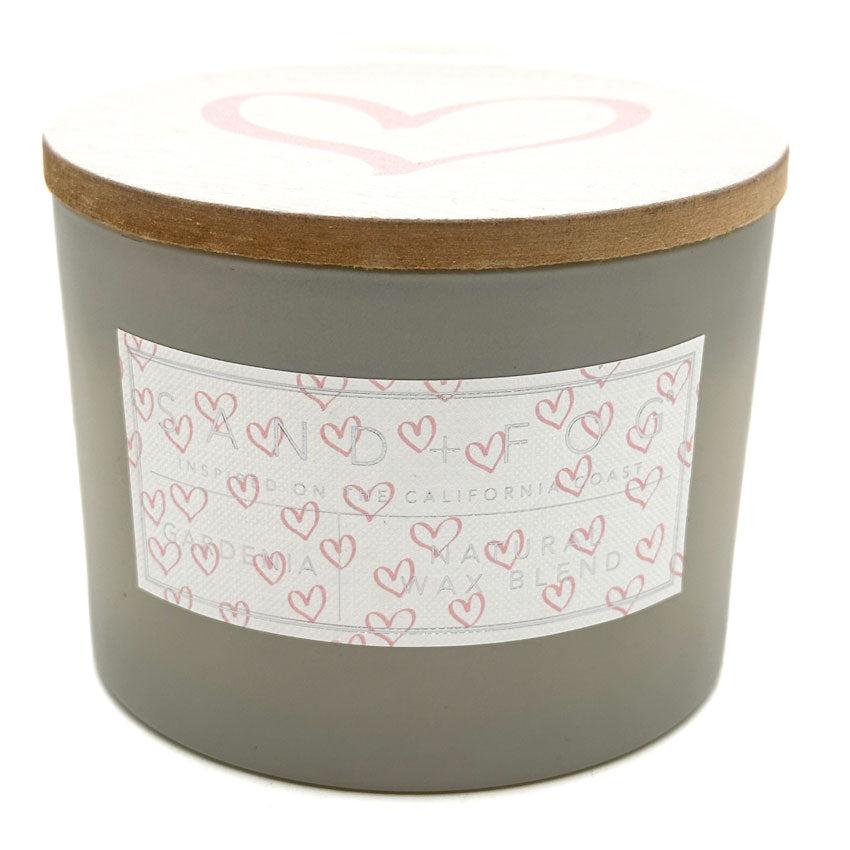 SAND + FOG Gardenia gray candle with a heart-patterned label on a white background