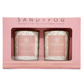 Sand + Fog candle set in pink packaging with two candles visible.
