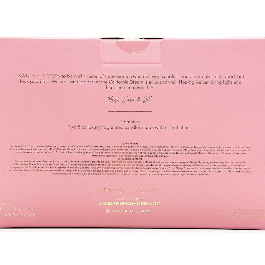 Pink box packaging for Sand & Fog candles with text and branding.