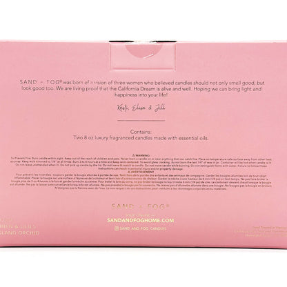 Pink box packaging for Sand & Fog candles with text and branding.