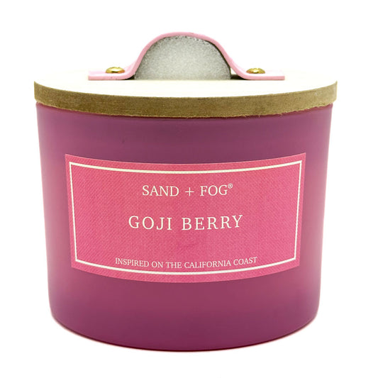 Goji Berry Pink candle with 'Sand + Fog' label on a white background