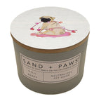 Goji Berry candle with a pug illustration on the lid and 'Sand + Paws' branding.