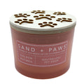Golden Nutmeg Candle with paw print design lid labeled 'Sand + Paws' on a white background