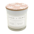 Golden Nutmeg Candle with a paw print lid labeled 'Sand + Paws' on a white background