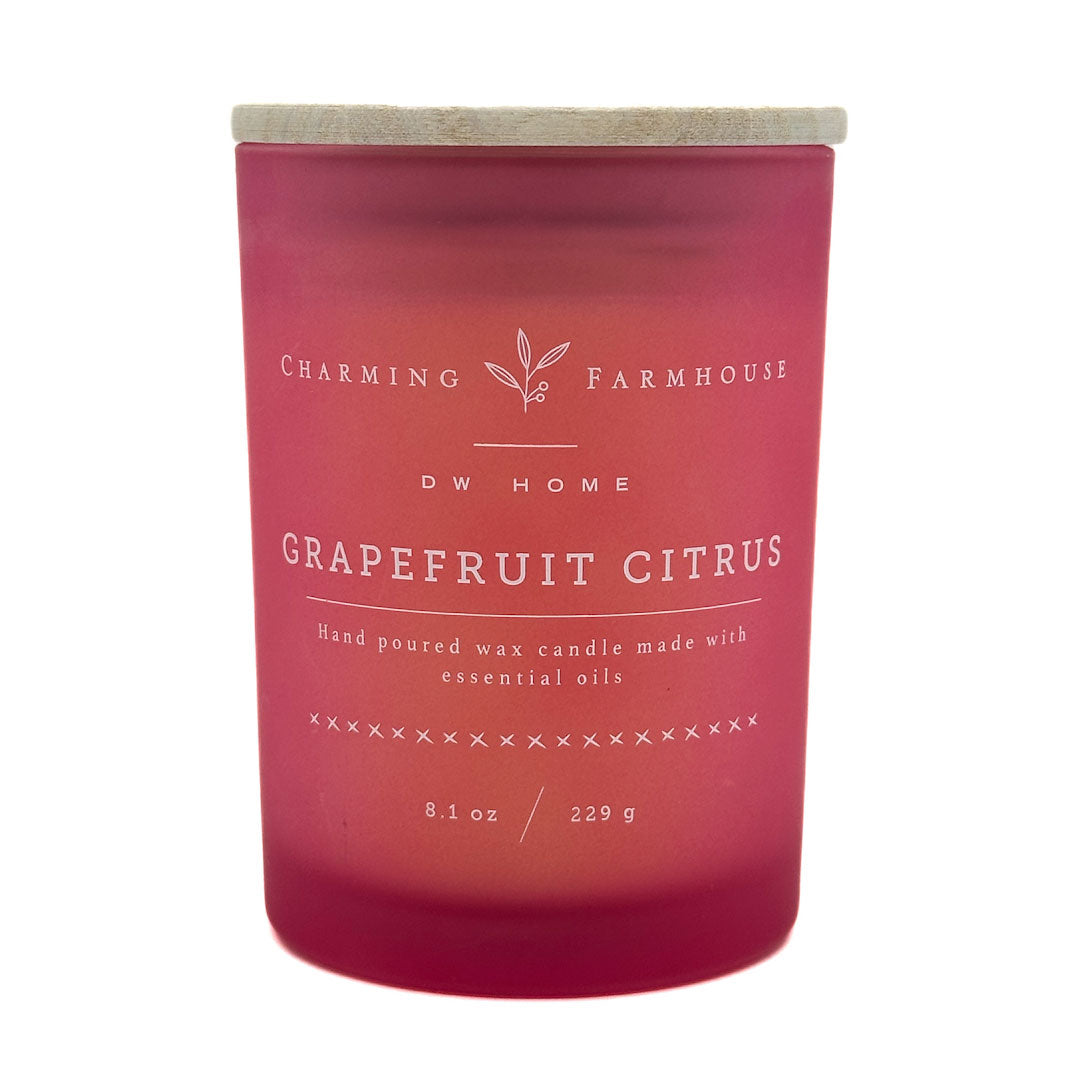 Pink grapefruit citrus candle with 'Charming Farmhouse' by DW Home branding on a white background