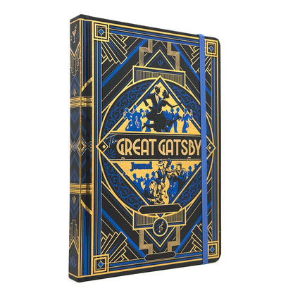 The Great Gatsby hardcover journal featuring an Art Deco design in black, blue, and gold. The cover displays a central diamond-shaped emblem with silhouettes of figures and the title 'The Great Gatsby' in gold lettering.
