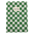 A woven notebook with a green and white checkered pattern, featuring a small beige label on the front that reads 'NOTES'.