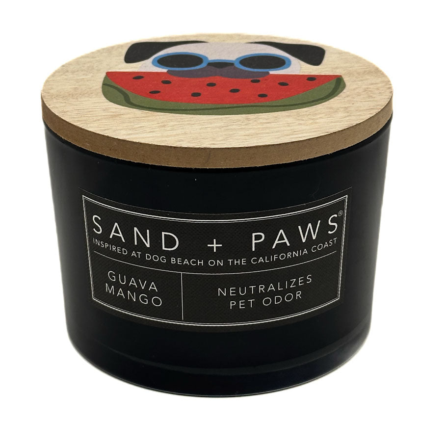 Guava Mango Black candle with a wooden lid featuring a dog and watermelon design, labeled 'Sand + Paws'.