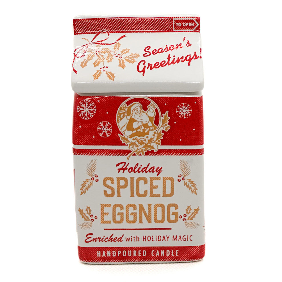 A handpoured holiday candle in a rectangular red and white box with festive illustrations and the text 'Holiday Spiced Eggnog' and 'Season's Greetings!'.
