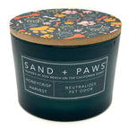 Honeycrisp candle container with 'Sand + Paws' branding and dog-themed lid on a white background