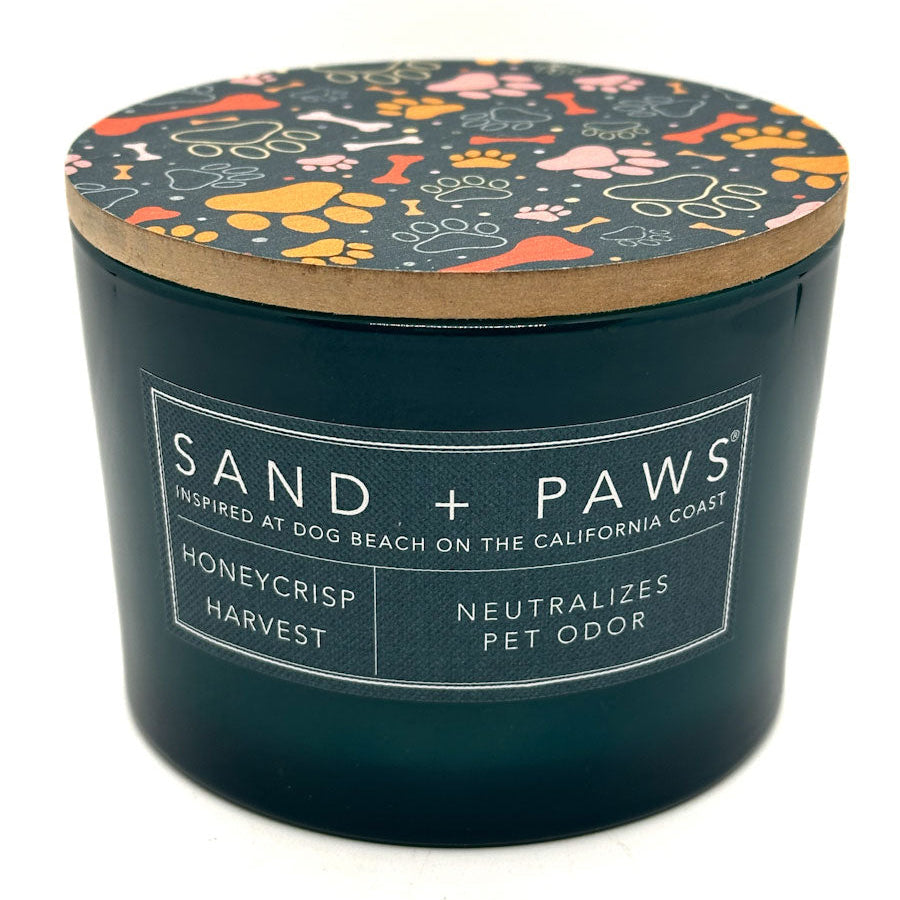 Honeycrisp candle container with 'Sand + Paws' branding and dog-themed lid on a white background