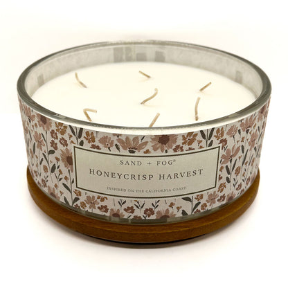 Candle with floral label on a white background