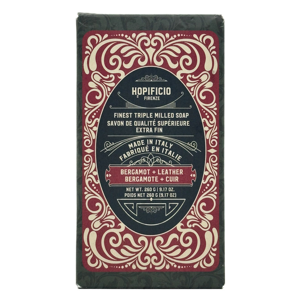 Bergamot + Leather bar of soap with decorative packaging on a white background