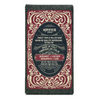 Bergamot + Leather bar of soap with decorative packaging on a white background