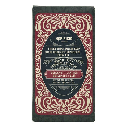 Bergamot + Leather bar of soap with decorative packaging on a white background