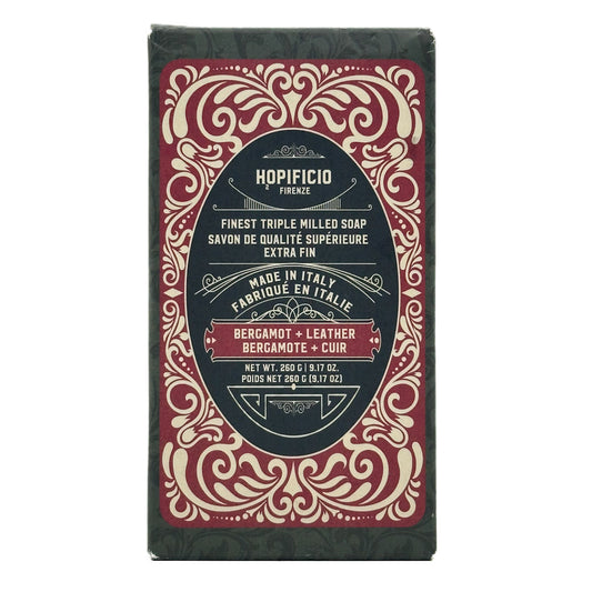 Bergamot + Leather bar of soap with decorative packaging on a white background