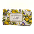 A rectangular bar of HOPIFICIO Firenze 'Italian Lemon' triple milled soap, wrapped in a white paper sleeve decorated with a vibrant yellow lemon and purple floral pattern, set against a plain white background.