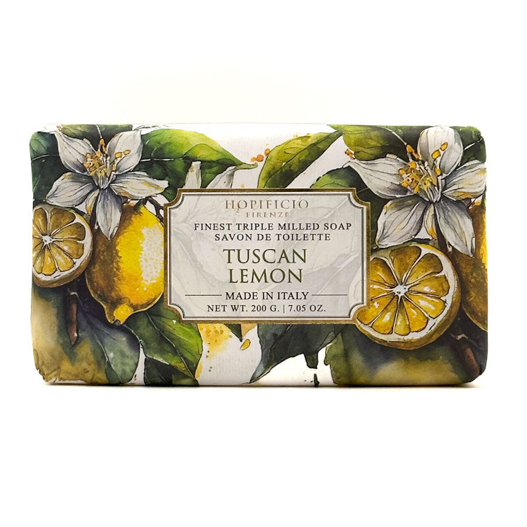 A rectangular bar of Horiﬁcio Firenze Tuscan Lemon soap, wrapped in a botanical illustration featuring lemons, green leaves, and white blossoms, with a central cream label.