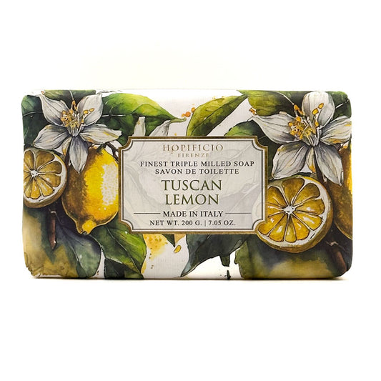A rectangular bar of Horiﬁcio Firenze Tuscan Lemon soap, wrapped in a botanical illustration featuring lemons, green leaves, and white blossoms, with a central cream label.