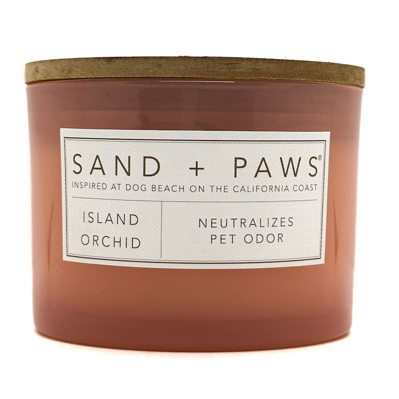 Island Orchid Candle with 'Sand + Paws' label on a white background