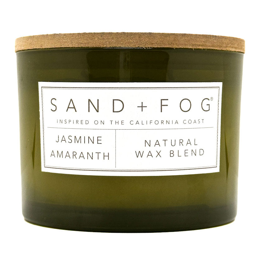 Jasmine Amaranth candle Green candle with a wooden lid and 'Sand + Fog' label on a white background