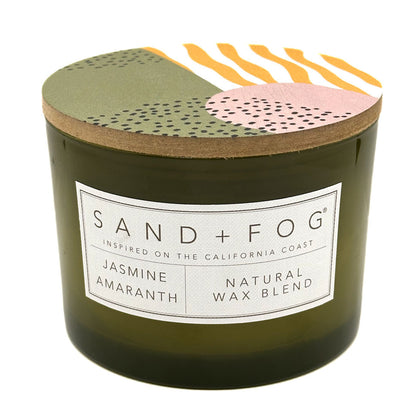 Jasmine Amaranth candle with a decorative lid featuring abstract patterns and 'Sand + Fog' branding.