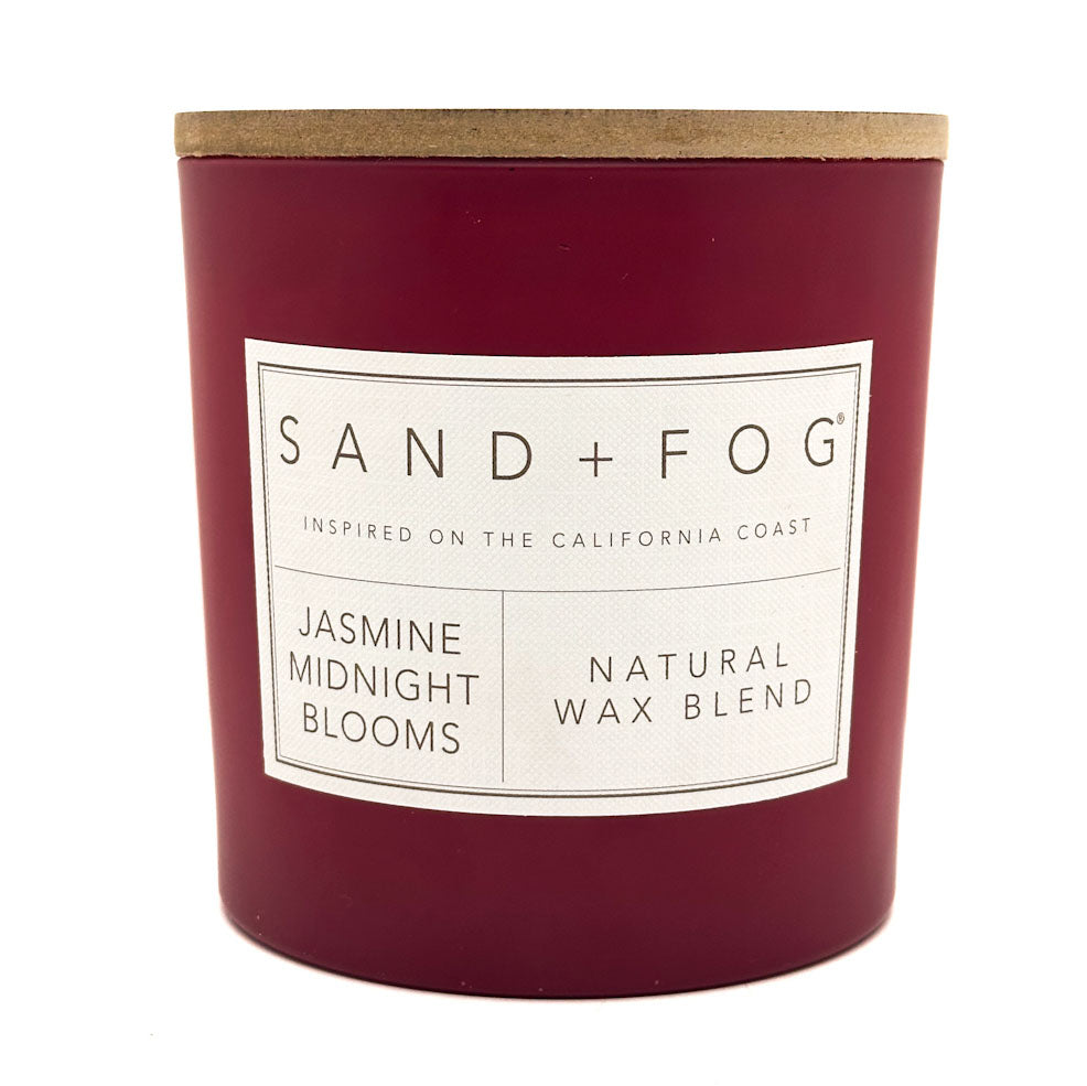 Jasmine Midnight Blooms Maroon candle with a wooden lid and 'Sand + Fog' label on a white background