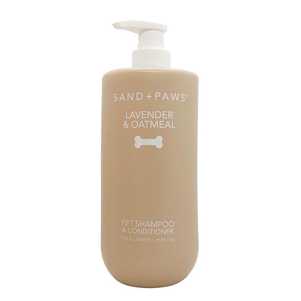 Beige bottle of Sand + Paws Lavender & Oatmeal pet shampoo and conditioner on a white background