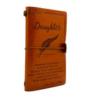 Brown leather journal with engraved text and a feather illustration on a white background