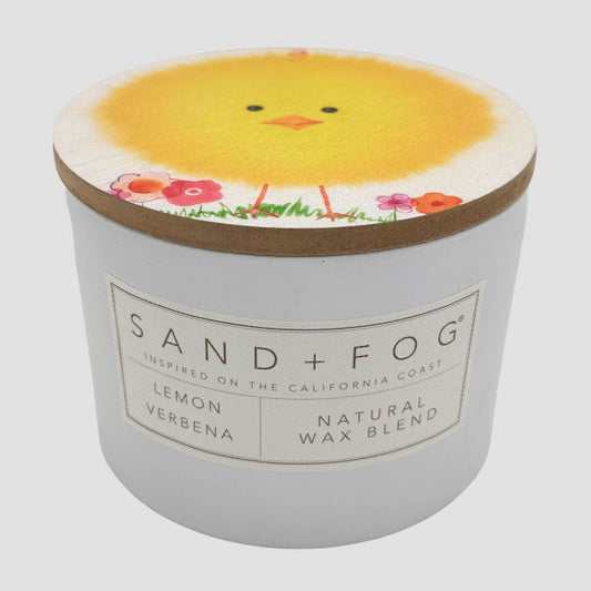 Lemon Verbena candle with a chick design on the lid and 'Sand + Fog' branding.