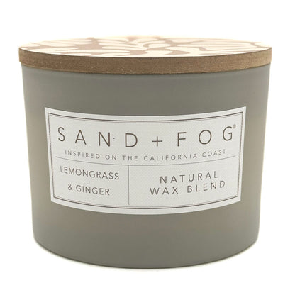 Gray Lemongrass & Ginger candle with a wooden lid labeled 'Sand + Fog' on a white background