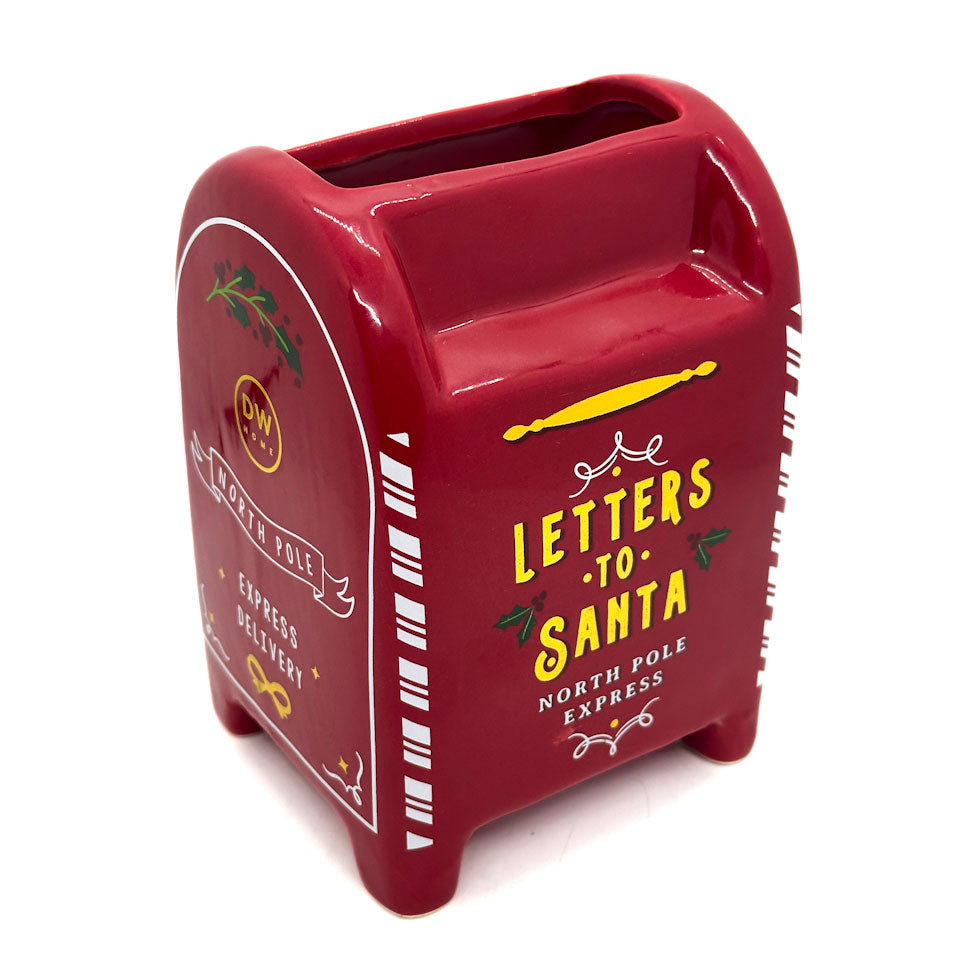 Red mailbox-shaped candle container with 'Letters to Santa' text on a white background