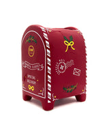 Red mail box candle with festive designs on a white background