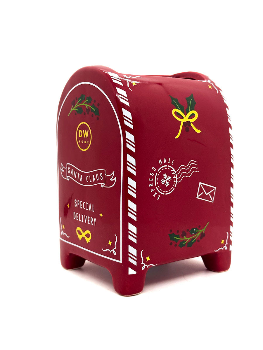 Red mail box candle with festive designs on a white background