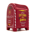Red mailbox-shaped candle container with 'Letters to Santa' text on a white background