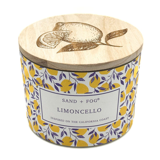 SAND + FOG Limoncello Candle with wooden lid featuring lemon design and 'Sand + Fog' branding.
