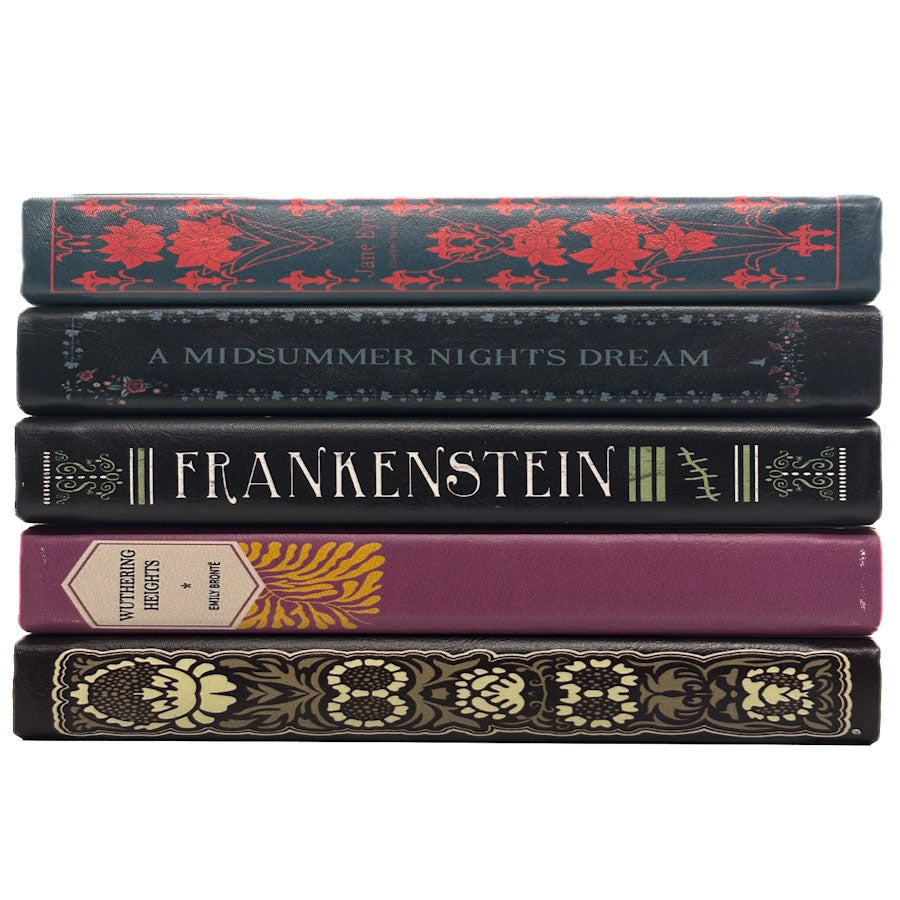 A stack of five decorative book spines on a plain white background, including titles such as Frankenstein and A Midsummer Night's Dream.