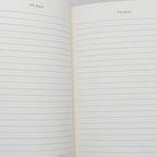 Open notebook with lined pages and 'it's yours.' text on a white background