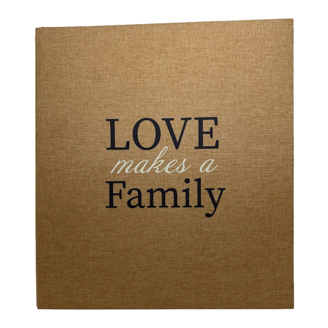 A square photo album canvas print with a brown linen-textured background and the phrase 'LOVE makes a Family' printed in the center. 'LOVE' and 'Family' are in dark navy blue serif font, while 'makes a' is in a light beige cursive font.