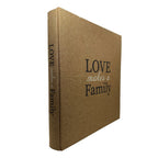 A hardcover photo album with a textured tan linen cover and black printed text reading 'LOVE makes a Family' on the front cover and spine, shown on a plain white background.